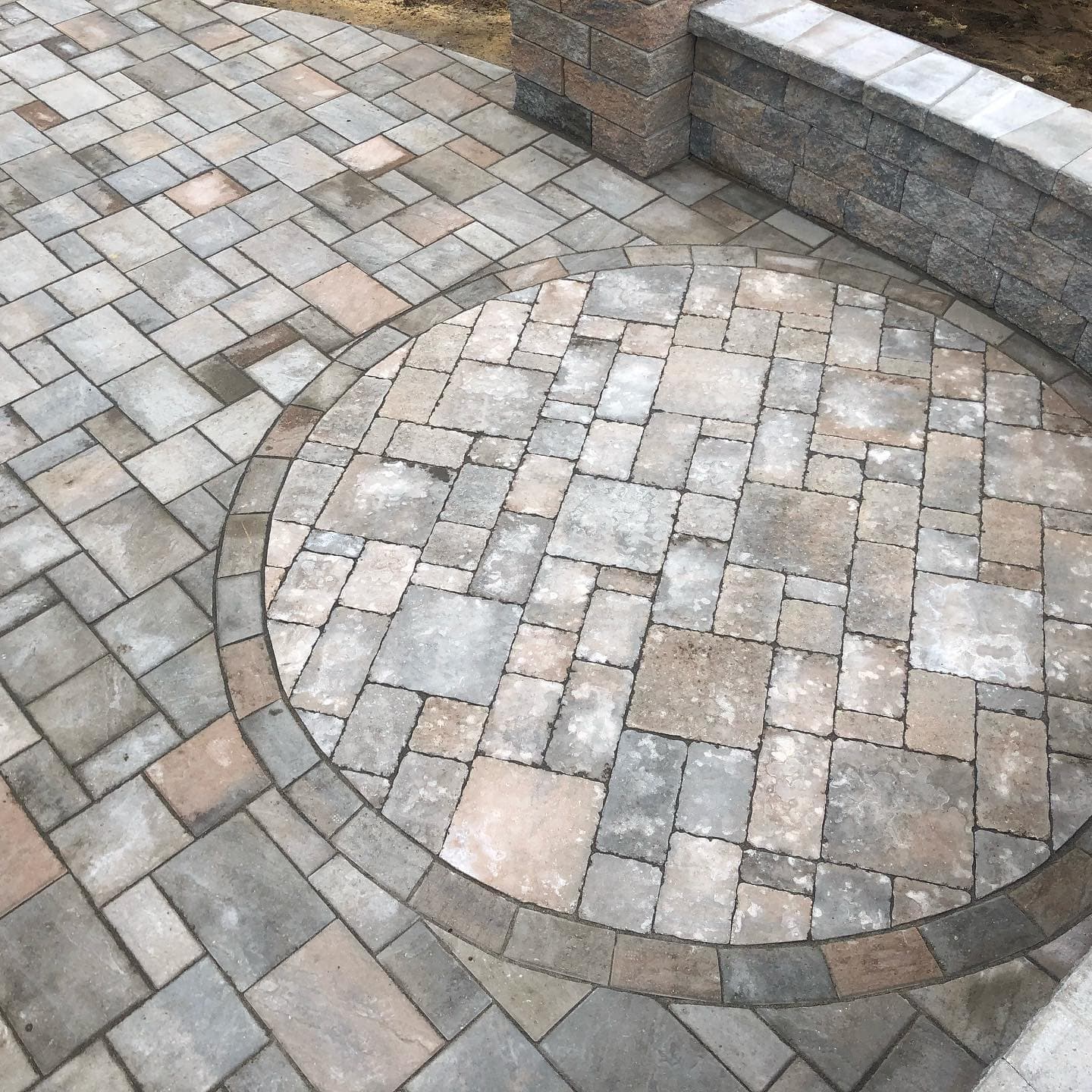 Close-up of a paver patio with a circle inlay
